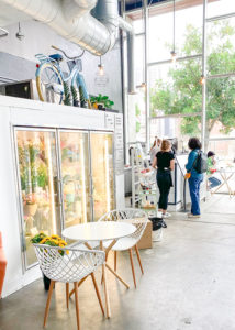 Inside of Adore Coffee House featuring fresh flowers. 