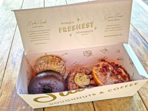 Fresh Sidecar donuts in the box: maple bacon, salted malted chocolate chip cookie dough, chocolate, and blueberry pancake