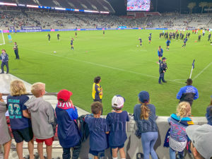 San Diego Wave soccer players sign autographs for young fans after the game.