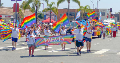 San Diego Pride 2023 Viejas float and parade marchers with rainbow flags.